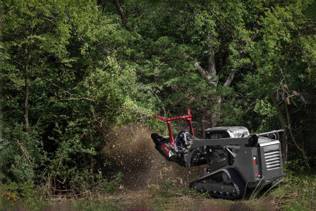 Skid steer loader performing professional forestry mulching
